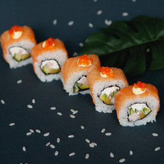 Japanese rolls on grey stone background.