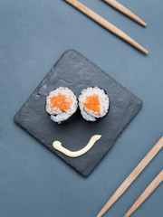 Japanese rolls on grey stone background.