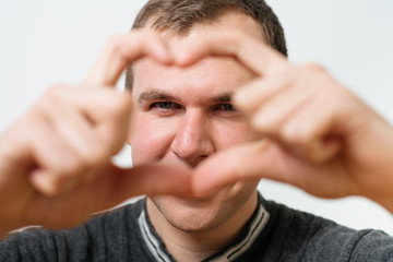 Fototapeta premium man making a hand heart frame