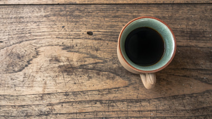 black coffee on wooden table. ceramic round cup.