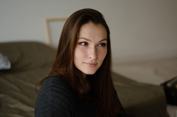  portrait of a young beautiful pensive girl at home