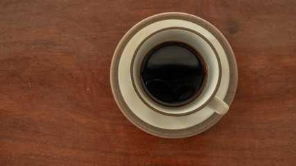 black coffee on wooden table. ceramic round cup. background,