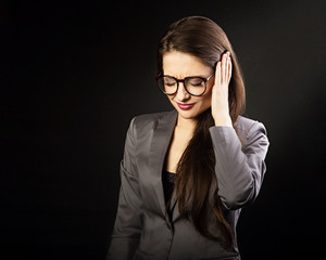 Very concentrated young woman in suit holding the head the hand and find the solution on problem situation. Corona virus. Studio portrait on grey background