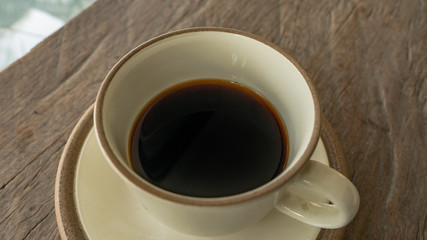 black coffee on wooden table. ceramic round cup. background,