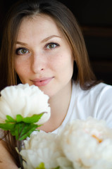portrait of a young beautiful girl in a room with flowers