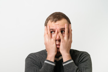  man covers his face by hand