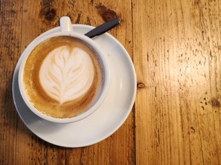 Cappuccino on wooden table directly above