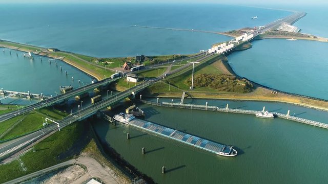 Enclosure Dam (Afsluitdijk): Large Cargo Ship Just Passed the Bridge Cross the Dam, Looking Up - Friesland, Netherlands / Holland &ndash; 4K Drone Footage