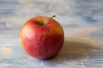 red apple on wooden table