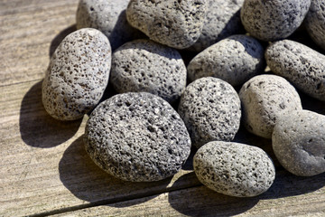 Fototapeta na wymiar volcanic lava pebbles background, porous lava stone textured surface