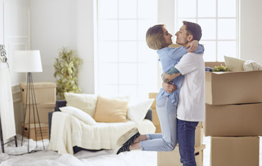 Happy smiling young couple showing a pair of keys of their new house