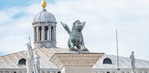 Obraz premium Panoramic view over San Marco square roof top towers, sculptures and the symbol of Venice a winged lion at Doge Palace, Venice, Italy, summer time, closeup, details