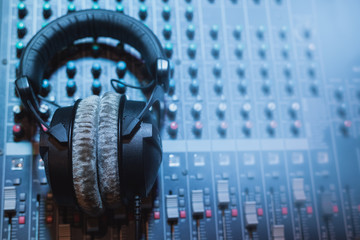 professional headphones and audio mixer or sound table.