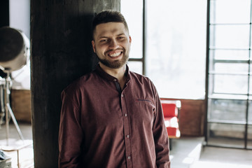  Happy young bearded man smiling on all teeth