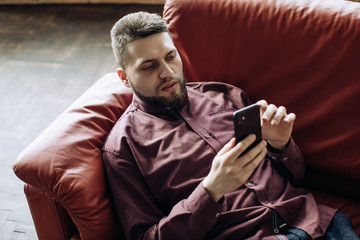 young bearded man with mobile phone