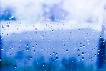 raindrops on the glass misted window, on a cold day indoors.