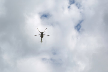 helicopter in flight against a cloudy sky