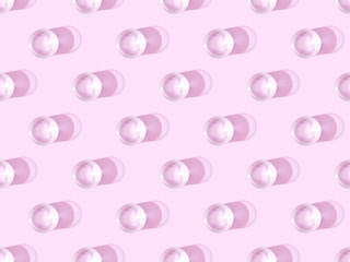 top view of glasses of water on violet, seamless background pattern