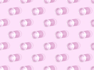 top view of glasses of water on violet, seamless background pattern