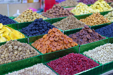 Market stall with various dried fruits and nuts