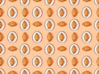 top view of fresh croissants on plates on orange, seamless background pattern
