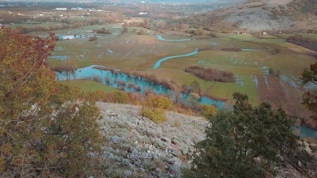  A River in a Marshy Area in Autumn. River Matica Landscape. Aerial Footage of a Swampy River and Green Flooded Fields From a Bird's Eye View. Rijeka Matica i Okolina u Jesenjim Bojama.