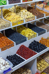 Market stall with various dried fruits and nuts