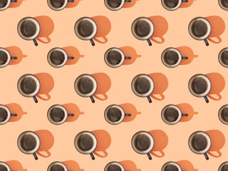 top view of cups of fresh coffee on orange, seamless background pattern