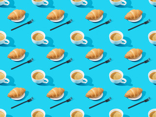 forks, fresh croissants on plates and coffee on blue, seamless background pattern