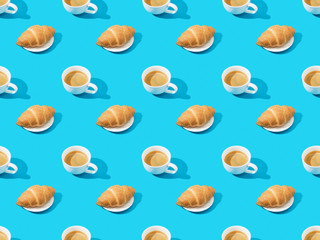 fresh croissants on plates and coffee on blue, seamless background pattern