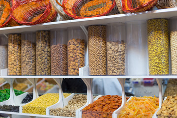 Market with various dried fruits, nuts and baskets.