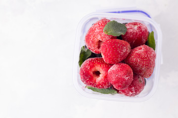 frozen strawberries on a white background top view. copy space