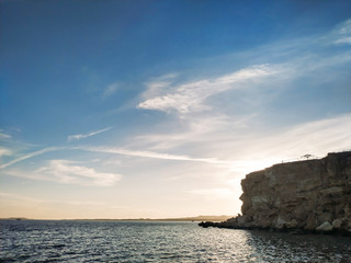 Sunset sky and rock near the sea