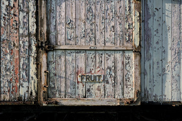 Abandoned train depot with various trains and carriages in different states of decay.