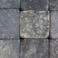 Stone background close-up. Natural texture. Light gray bluish backdrop or wallpaper. Rough surface. Reduced contrast. Square shot. Macro