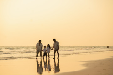 Pictures of families with grandfathers, grandmothers and children happily strolling along the beach
