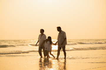 Pictures of families with grandfathers, grandmothers and children happily strolling along the beach