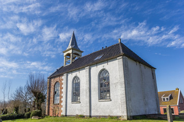 Fototapeta na wymiar Little white church in the historic town of Jukwerd, Netherlands