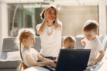 Fototapeta na wymiar Coronavirus theme. Mother with children. Family stay at home. Kids watchs a cartoons.