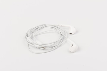 White headphones for listening to music and sound on portable devices: music player, smartphone, laptop and jack for connection on a white background.