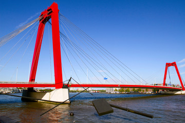 ROTTERDAM , NETHERLANDS. On July 05,  2019. A view of the  Willemsbrug    Bridge  in  Rotterdam. Bright red bridge with a total length of about 318 meters.  Was built in 1878. European travel. 