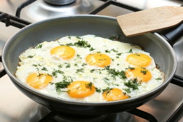 Close-up photo of scrambled eggs in black frying pan