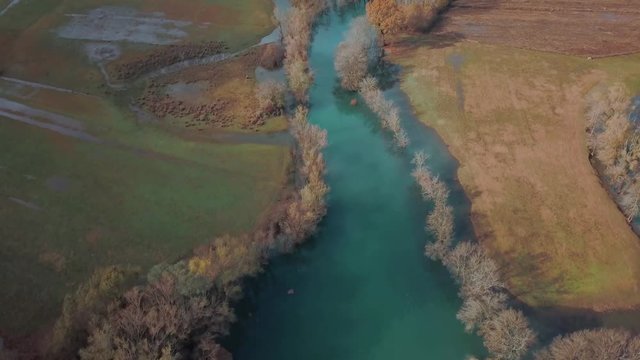 Blue Autumn Swampy River. Swampy Landscape Matica River. Aerial Footage of a Swampy River and Green Flooded Fields From a Bird's Eye View. Rijeka Matica kod Luznice Komani