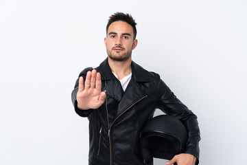 Naklejka premium Man with a motorcycle helmet making stop gesture and disappointed