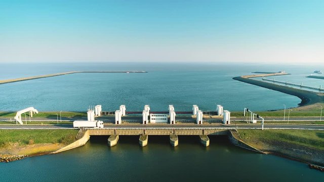 Enclosure Dam (Afsluitdijk): Trucks and Cars Crossing a Sluice, Stationary Shot - Friesland, Netherlands / Holland &ndash; 4K Drone Footage