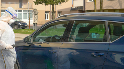 CLOSE UP: Medical specialist disinfects car handles during coronavirus pandemic.