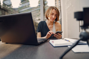 Fototapeta premium Woman working at home. Businesswoman on quarantine. Lady shoots a blog.