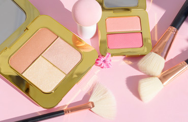 premium makeup brushes, sponge and blush pads on a bright colorful pink and blue background,...