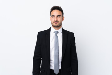 Young business man over isolated background standing and looking to the side
