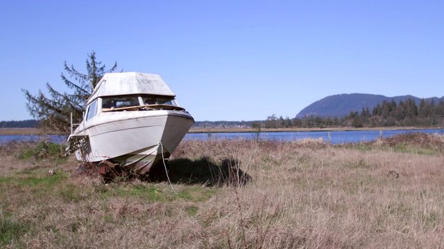 Abandoned pleasure boat besie river